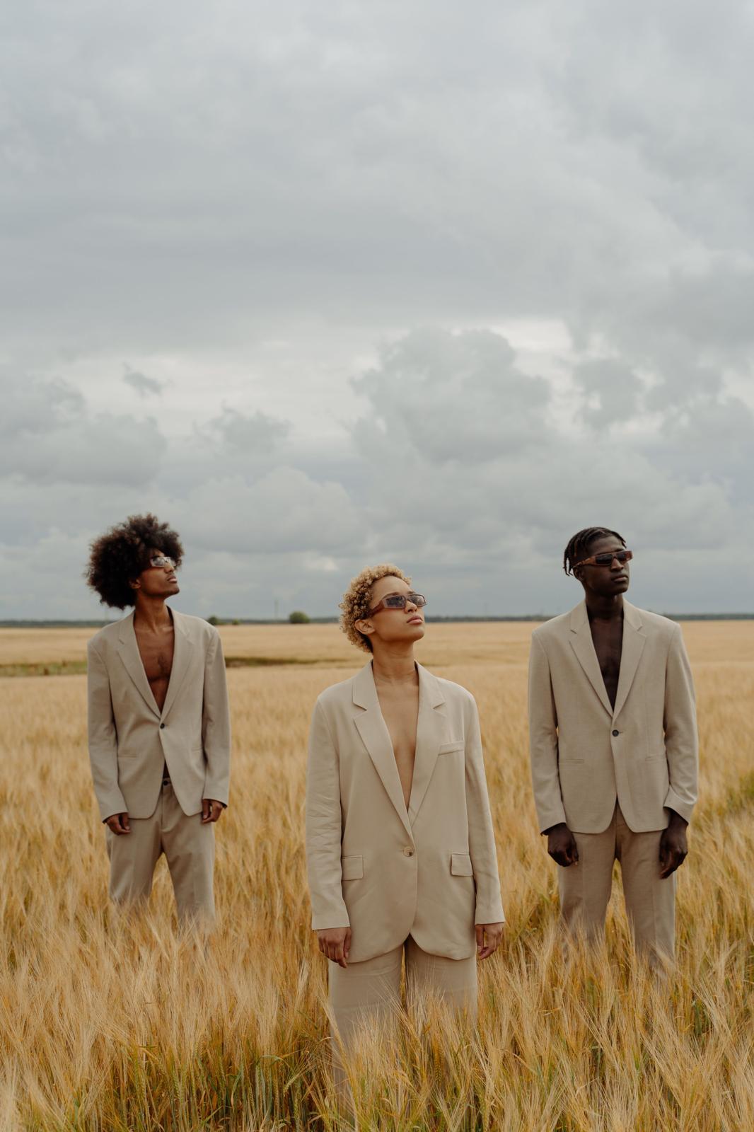 Three people in beige clothing in a quiet field representing the Nafsy community
