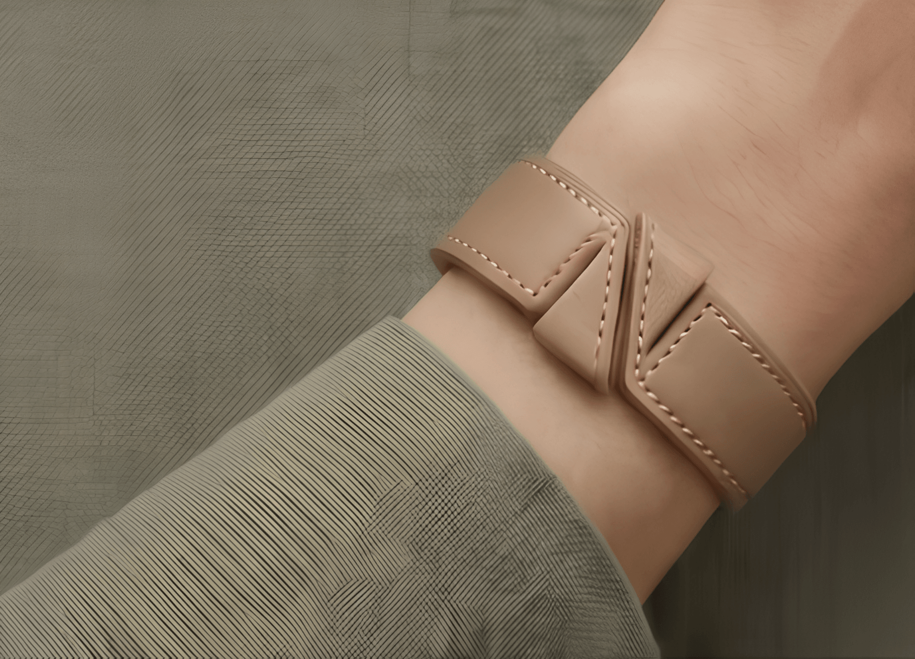 Close-up of the Nafsy leather bracelet on a wrist with a beige knit sleeve