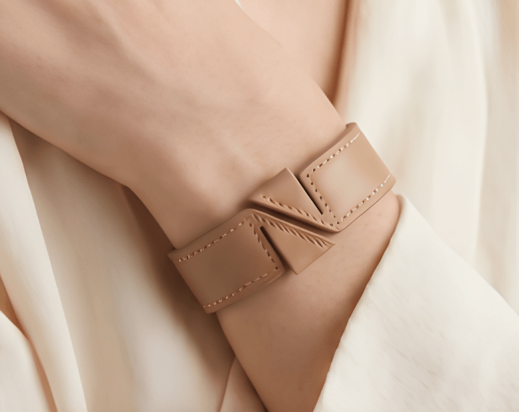 Nafsy bracelet worn on a wrist with a soft white sleeve — a moment of calm